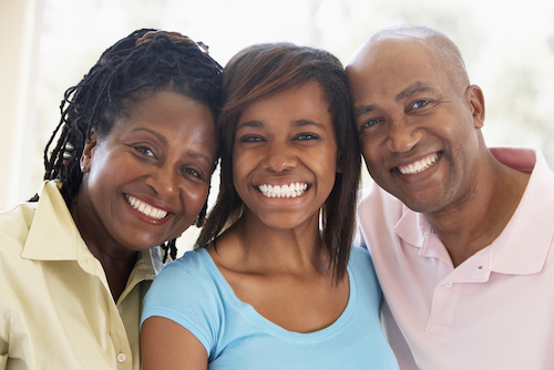 mother and father posing with teenage daughter